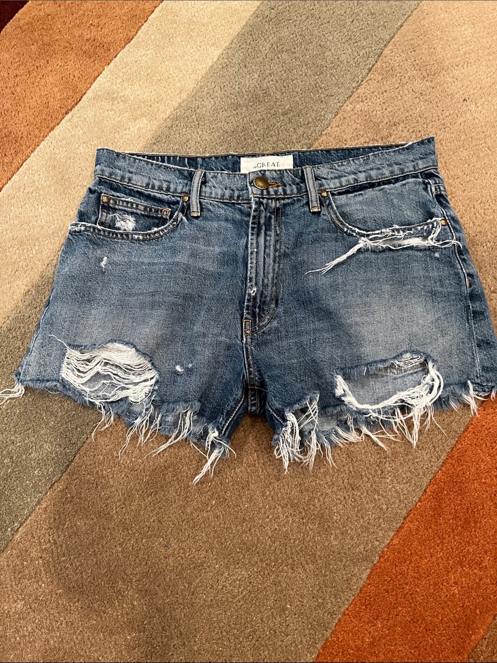 THE GREAT. Washed Blue Distressed Denim Cutoff Shorts